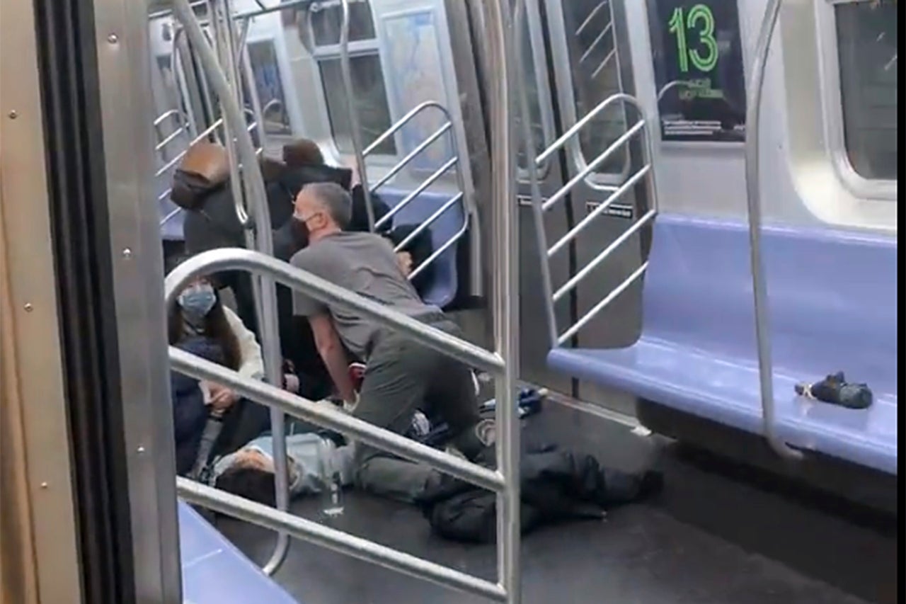 A person is aided in a subway car.