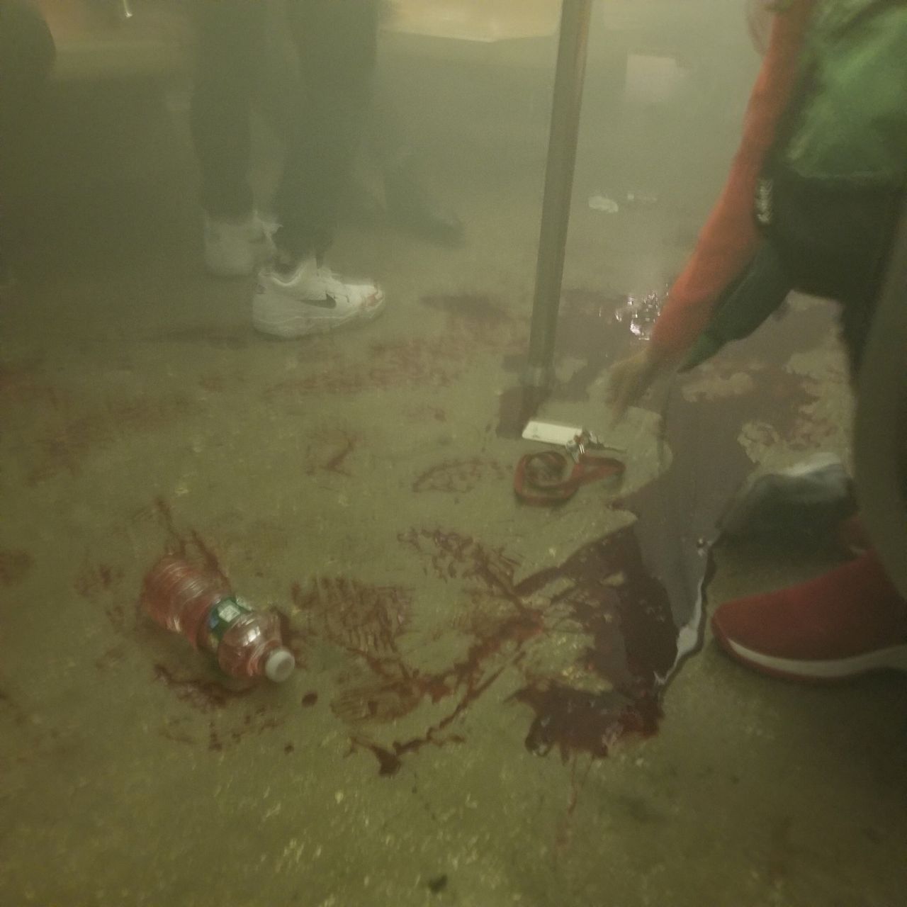 Blood is seen on the floor of a subway train. 