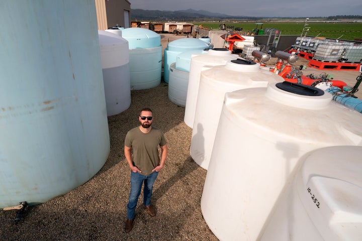 William Terry, of Terry Farms, poses among fertilizer tanks at his farm on March 31, 2022, in Oxnard, Calif.