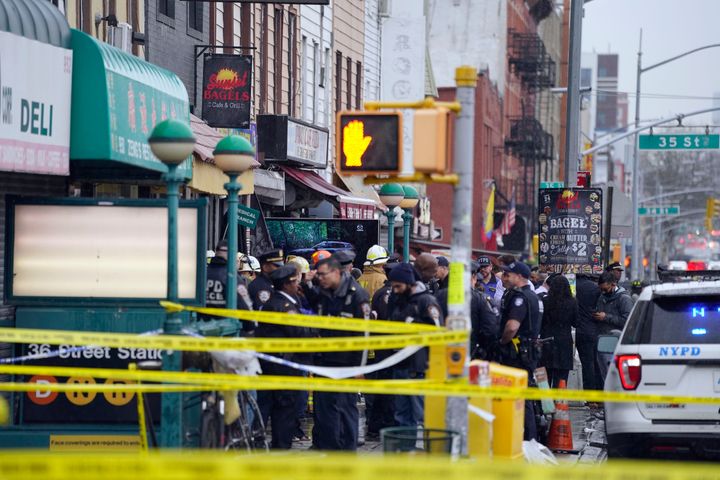 Emergency personnel gather at the entrance to a subway stop in the Brooklyn borough of New York, on April 12, 2022.