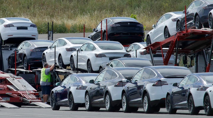 Tesla cars are loaded onto carriers at the Tesla electric car plant in Fremont, Calif., on May 13, 2020.