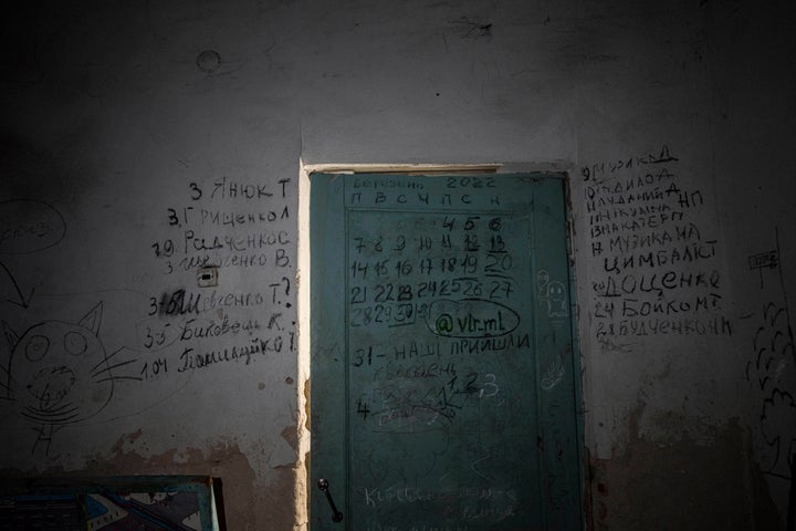 Writing covers a wall and a door in the basement of a school in Yahidne, near Chernihiv, Ukraine, on April 12, 2022.