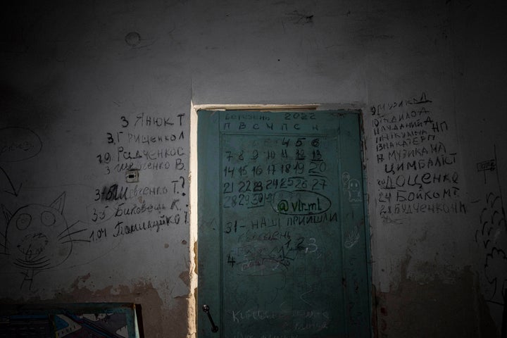 Writing covers a wall and a door in the basement of a school in Yahidne, near Chernihiv, Ukraine, on April 12, 2022. 