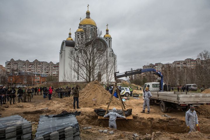 Forensic technicians exhume the bodies of civilians who Ukrainian officials say were killed during Russia's invasion and then buried in a mass grave in the town of Bucha, outside Kyiv.