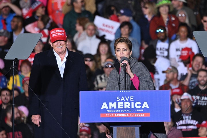 Former President Donald Trump and Kari Lake, whom Trump is supporting in the Arizona's gubernatorial race, speak during a rally at the Canyon Moon Ranch festival grounds in Florence, Arizona, southeast of Phoenix, on Jan. 15, 2022.