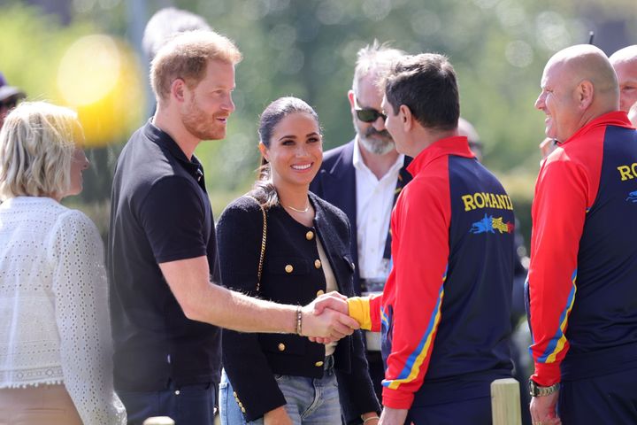The Sussexes talk to members of Team Romania during the Jaguar Land Rover Driving Challenge on Day One of the Invictus Games at The Hague on April 16.