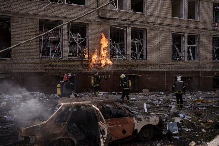 Firefighters work to extinguish multiple fires after a Russian attack in Kharkiv, Ukraine, Saturday, April 16, 2022.