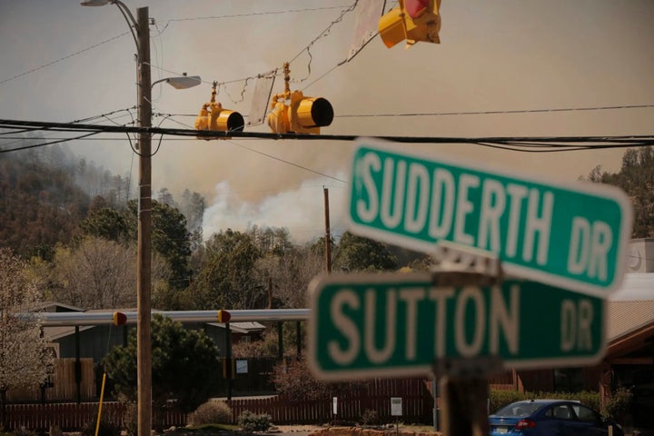 Smoke from the McBride Fire rises near an intersection in Ruidoso, New Mexico, on Wednesday, April 13, 2022.