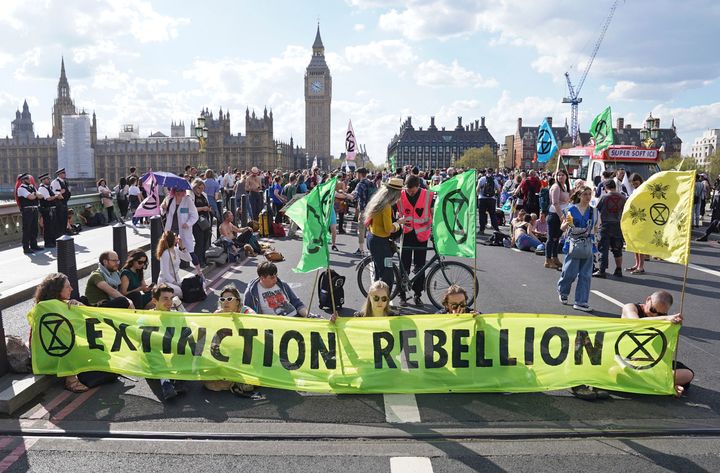 Demonstrators take part in an Extinction Rebellion protest on Westminster Bridge in London, Friday, April 15, 2022.