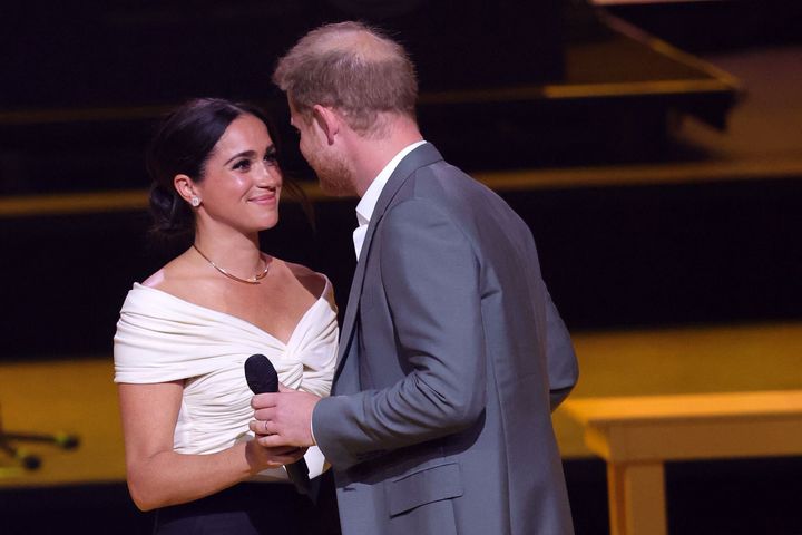 The Duke and Duchess of Sussex share a sweet moment onstage before Prince Harry speaks.