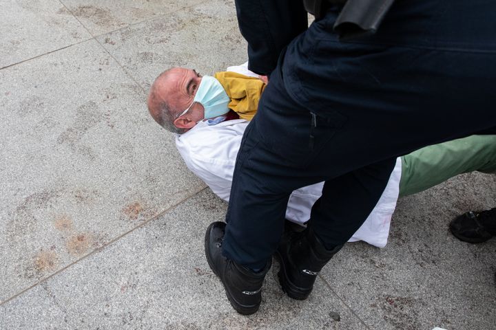 A climate protester in Madrid being grabbed by police.