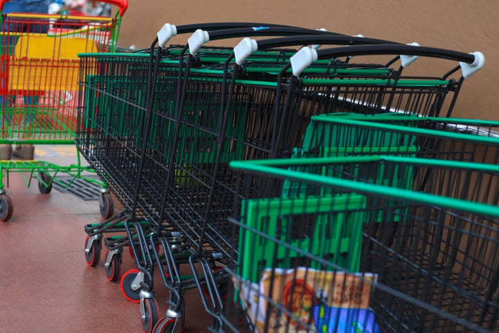 Supermarket carts lined up outside a shopping mall.