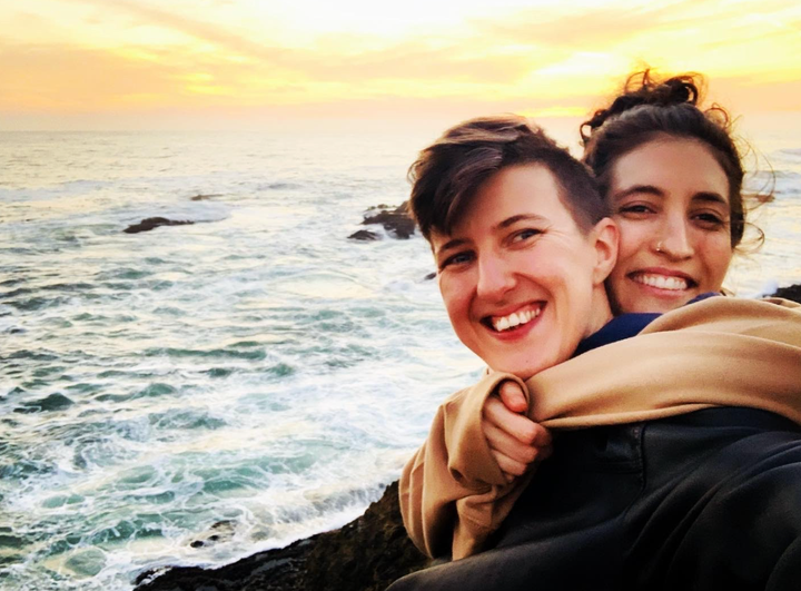 The author (right) and her partner, Liam, sitting by the sea in Northern California in January 2022.