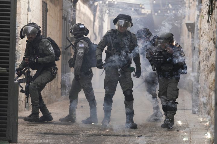 Palestinians release fireworks at Israeli police in the Old City of Jerusalem, Sunday, April 17, 2022.