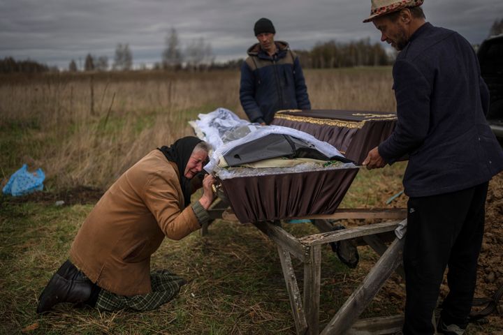 Nadiya Trubchaninova, 70, cries while holding the coffin of her son Vadym, 48, who was killed by Russian soldiers in Bucha, during his funeral in the cemetery of Mykulychi, on the outskirts of Kyiv on April 16.