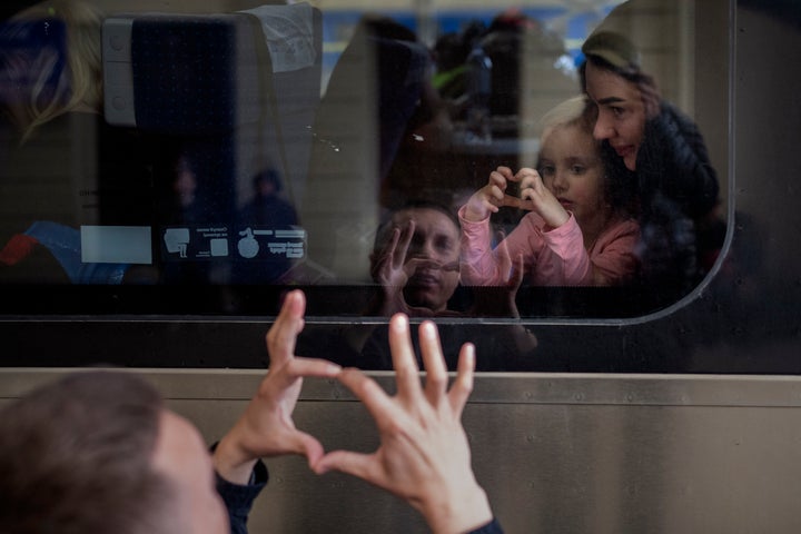 Ukrainian Nicolai, 41, says goodbye to his daughter Elina, 4, and his wife, Lolita, on a train bound for Poland fleeing the war at the train station in Lviv, in western Ukraine, on April 15.