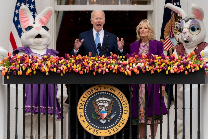 President Joe Biden, accompanied by first lady Jill Biden and Easter Bunnies, speaks on the Blue Room balcony at the White House during the Easter Egg Roll, Monday, April 18, 2022, in Washington. (AP Photo/Andrew Harnik)
