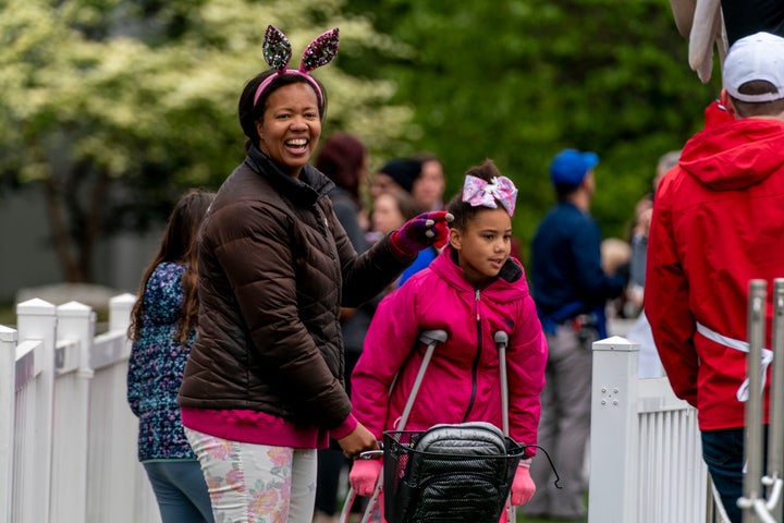 People walk on the South Lawn of the White House in Washington, Monday, April 18, 2022, during the White House Easter Egg Roll. (AP Photo/Andrew Harnik)