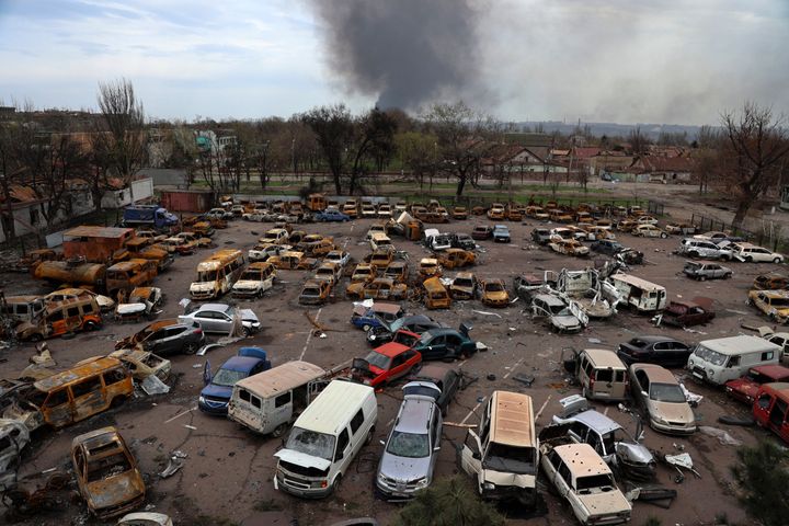 Heavily damaged vehicles are seen at a destroyed part of the Illich Iron & Steel Works Metallurgical Plant, as smoke rises from the Metallurgical Combine Azovstal, in an area controlled by Russian-backed separatist forces in Mariupol, Ukraine, on April 18, 2022. 