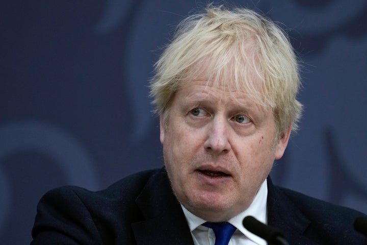 British Prime Minister Boris Johnson delivers a speech at Lydd Airport, south east England, Thursday, April 14, 2022. Britain says it has struck a deal with Rwanda to send some asylum-seekers to the central African country, a proposal that has been condemned by opposition politicians and refugee groups. (AP Photo/Matt Dunham, Pool)