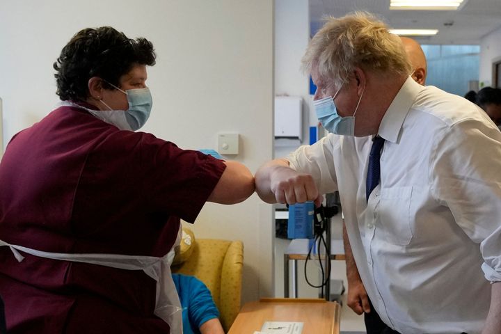 Boris Johnson wearing a face covering to mitigate the spread of Covid-19 at the New Queen Elizabeth II Hospital in Welwyn Garden City
