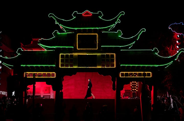 A model is framed in the East Gate at Old Chinatown Plaza as she walks the runway at fashion designer Alexander Wang's "Fortune City" runway show and party celebrating Asian-American culture, Tuesday, April 19, 2022, in Los Angeles. (AP Photo/Chris Pizzello)