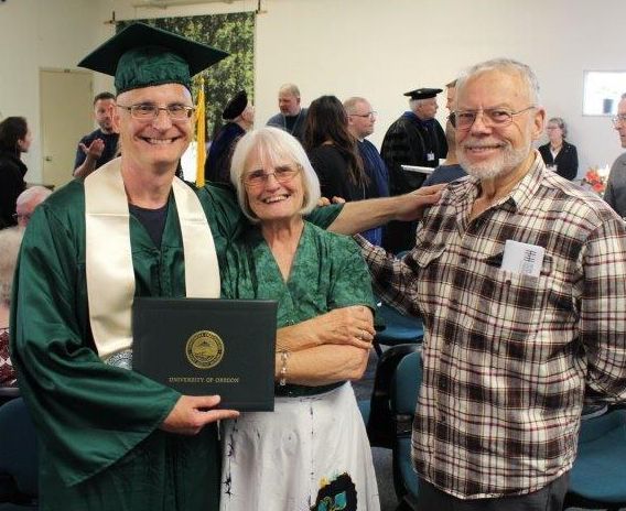 Mark Wilson with his parents at his commencement ceremony for his bachelor's degree from the University of Oregon, held at Oregon State Correctional Institution.