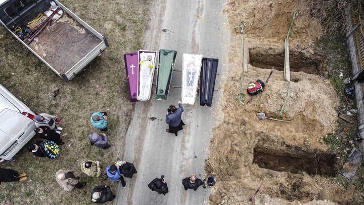 Funeral of civilians allegedly killed by Russian troops is held as relatives and family members attend burial at Bucha cemetery in Kyiv Oblast, Ukraine on April 20, 2022.
