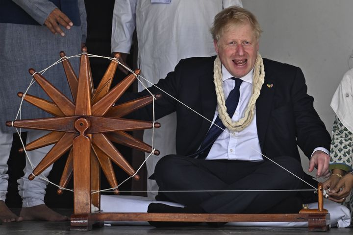 Boris Johnson spins khadi on a charkha during his visit to Mahatma Gandhi's Sabarmati Ashram in Ahmedabad, as part of his two day trip to India. 