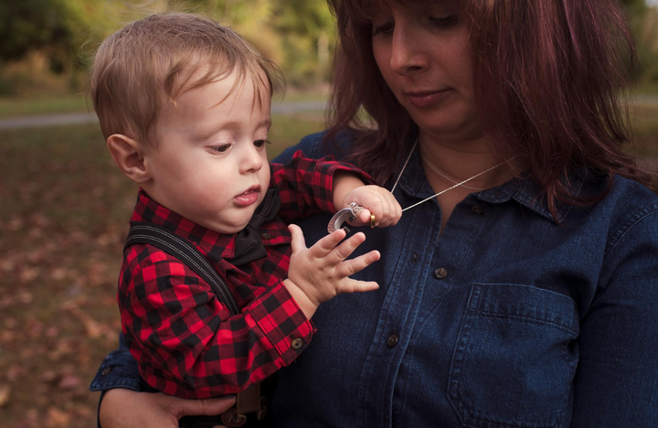 The author with her son M in 2019. "The only photos I have with my twins are with my survivor, M, with Nicholas's ashes. This is as close as I've ever come to holding both my twins together," she writes.