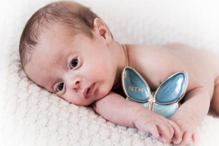 M with Nicholas' urn in 2019. This was shortly after he came home from the NICU.