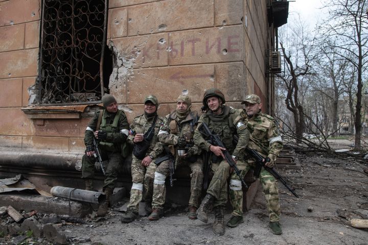 Russian fighters rest behind a building some 500m from Ukrainian positions around the embattled Azovstal plant in Mariupol. The battle between Russian / Pro Russian forces and the defending Ukrainian forces led by the Azov battalion continues in the port city of Mariupol.