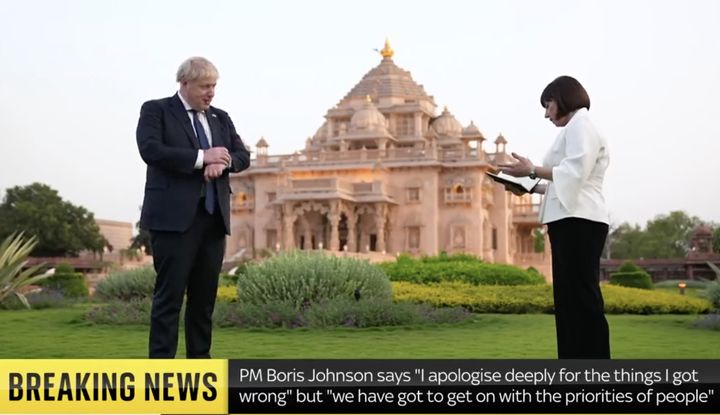 Boris Johnson checks his watch while being questioned about the partygate scandal.