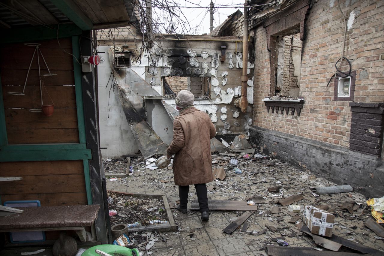 An elderly woman walks amid destruction in Bucha after the Ukrainian army secured the area following the withdrawal of the Russian army from the Kyiv region on previous days.