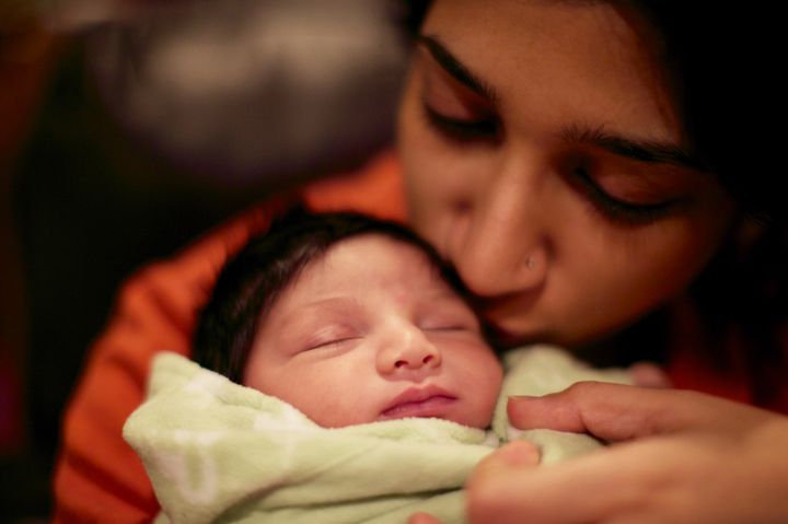 Rehma, just few days days old in January 2012, sleeping in the author's arms.