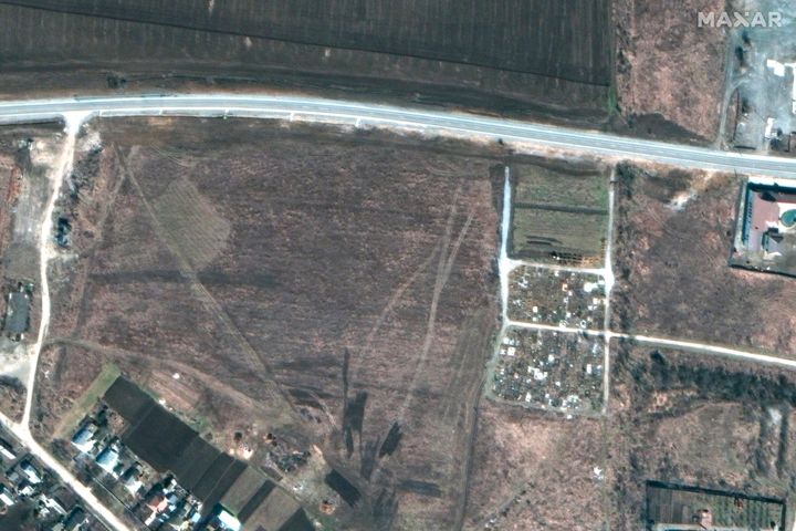This satellite image shows an overview of the cemetery in Manhush, some 20 kilometers west of Mariupol, Ukraine. Ukrainian officials say the Russians have been burying Mariupol residents killed in the fighting there.