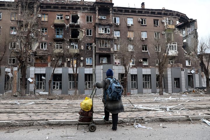 A local resident looks at a damaged during a heavy fighting near the Illich Iron & Steel Works Metallurgical Plant in Mariupol, Ukraine. 