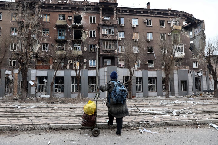 A local resident looks at a damaged during a heavy fighting near the Illich Iron & Steel Works Metallurgical Plant in Mariupol, Ukraine.