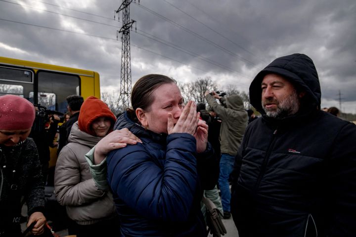 People fleeing fighting in the southern city of Mariupol meet with relatives and friends after the opening of a humanitarian corridor.