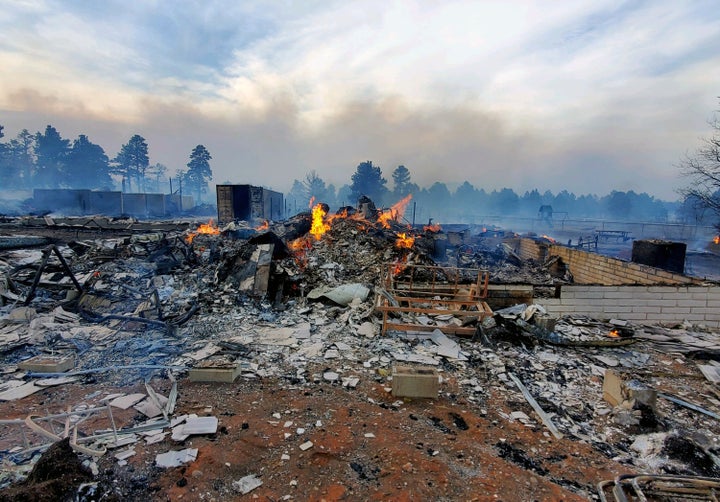This Wednesday April 20, 2022, photo provided by Bill Wells shows his home on the outskirts of Flagstaff, Ariz., destroyed by a wildfire on Tuesday, April 19, 2022. The wind-whipped wildfire has forced the evacuation of hundreds of homes and animals. (Bill Wells via AP)