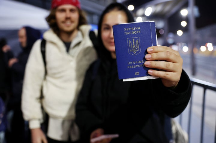 Sasha, a Ukrainian seeking asylum in the U.S., displays her passport as she waits to cross the U.S.-Mexico border at the San Ysidro Port of Entry amid the Russian invasion of Ukraine on April 5, in Tijuana, Mexico. 