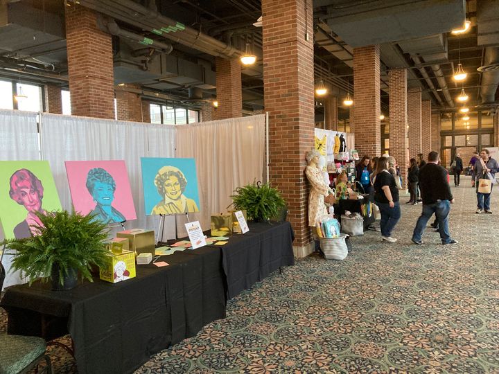 Attendees walk around a vendors' market at the first ever "The Golden Girls" fan convention Friday, April 22, 2022, at the Navy Pier in Chicago. Golden-Con, which lasts thru Sunday, is giving those who adored the NBC sitcom a chance to mingle, see panels and buy merchandise. The show, which ran from 1985-1992, starred Bea Arthur, Rue McClanahan, Estelle Getty and Betty White—who died at age 99 in December.