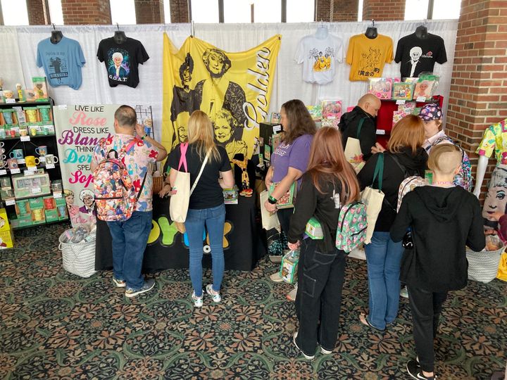 Fans of "The Golden Girls" TV show browse a merchandise booth in Chicago, Friday, April 22, 2022. Golden-Con, which lasts thru Sunday, is giving those who adored the NBC sitcom a chance to mingle, see panels and buy merchandise. The show, which ran from 1985-1992, starred Bea Arthur, Rue McClanahan, Estelle Getty and Betty White—who died at age 99 in December.