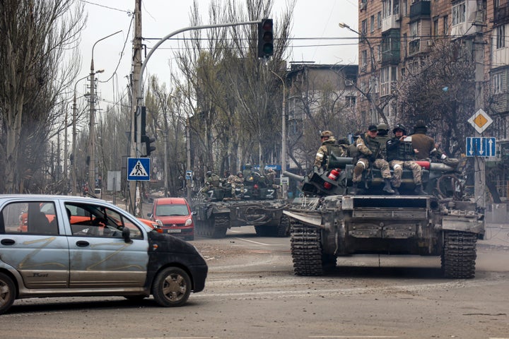 Russian tanks roll along a street in an area controlled by Russian-backed separatist forces in Mariupol, Ukraine, on April 23, 2022.