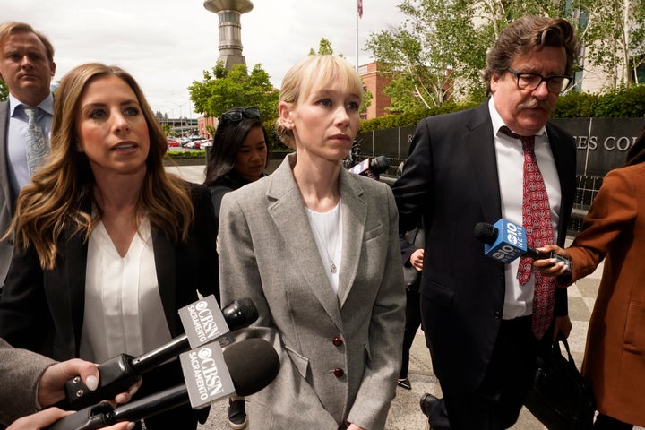 Sherri Papini walks to a federal courthouse in Sacramento, California, on April 13 while accompanied by her attorney, William Portanova, right.