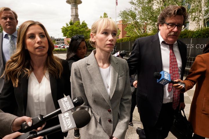 Sherri Papini walks to a federal courthouse in Sacramento, California, on April 13 while accompanied by her attorney, William Portanova, right. 