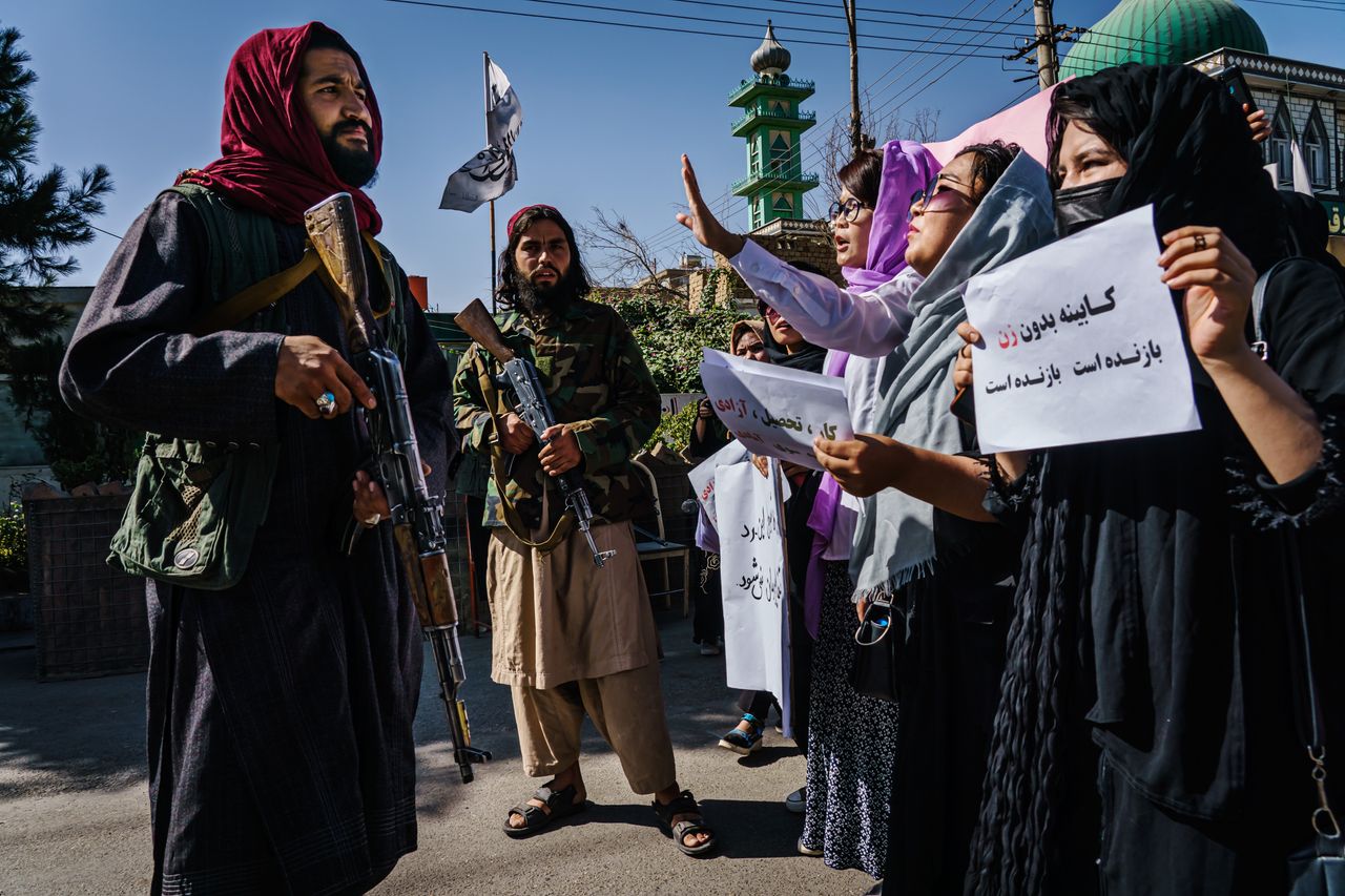 Taliban fighters try to stop the advance of protesters marching through the Dashti-E-Barchi neighborhood, a day after the Taliban announced its new all-male interim government with no representation for women and ethnic minority groups, in Kabul, Afghanistan, Sept. 8, 2021.