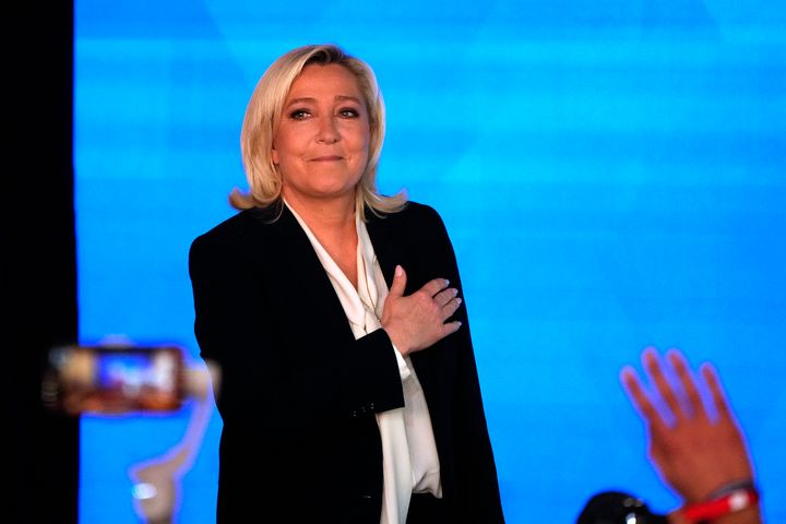 Marine Le Pen gestures as she arrives to speak after the early result projections of the French presidential election runoff were announced in Paris.