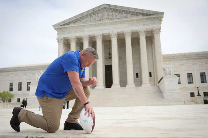 Former Bremerton High School assistant football coach Joe Kennedy takes a knee in front of the Supreme Court after his legal case, Kennedy v. Bremerton School District, was argued before the court on April 25.