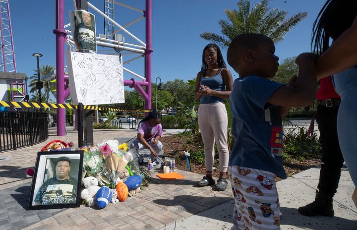A family member lights candles at a memorial for Tyre Sampson, 14, who was killed when he fell from the Orlando FreeFall ride at Icon Park in Orlando, Florida, on March 24.
